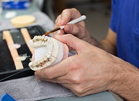 Model smile being worked on by technician