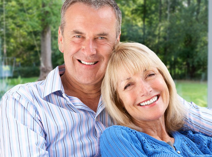 Older man and woman smiling outdoors