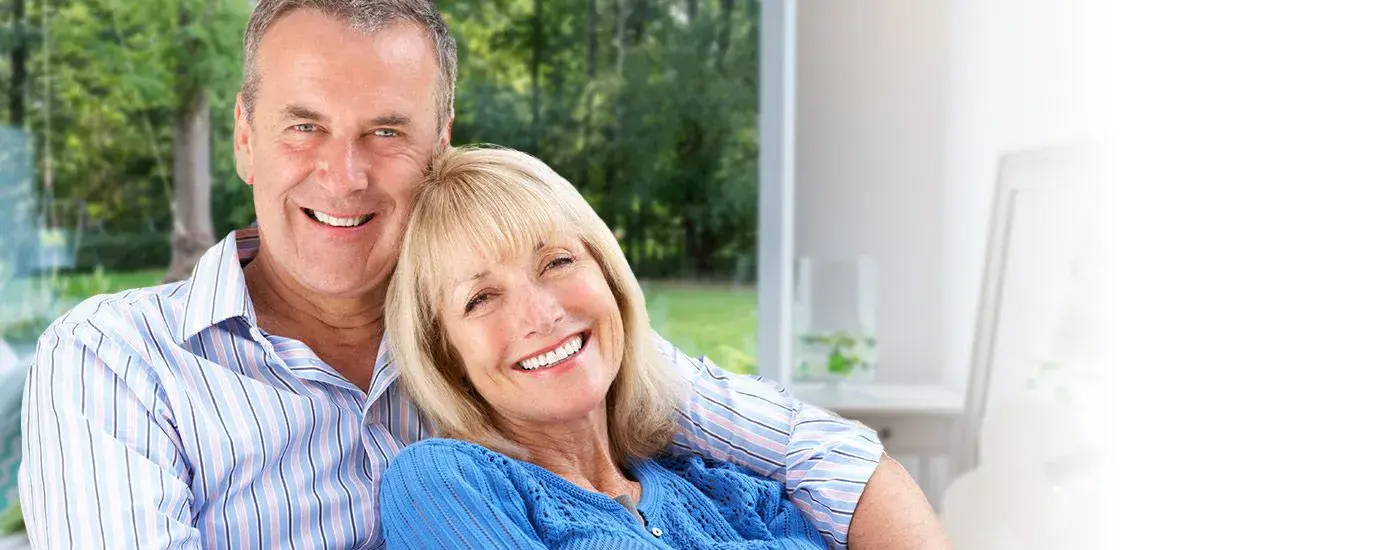Older man and woman smiling outdoors