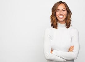 Woman in white turtle neck with shoulder length brown hair smiling