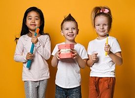 smiling young boy getting teeth checked by female hygienist