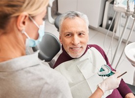 An elderly man getting dentures from his local dentist