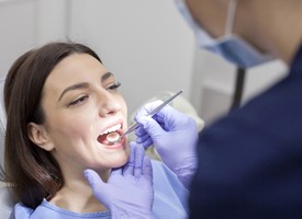 lady brown hair receiving dental exam