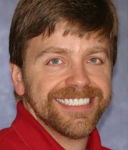 Man smiling after tooth alignment and teeth whitening