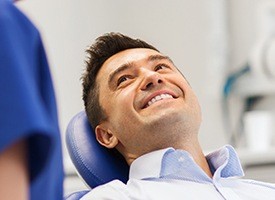 Man in dental chair smiling at dentist