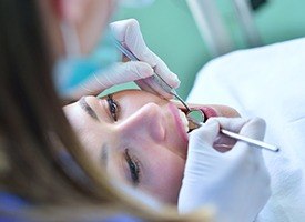 Relaxed woman receiving dental care