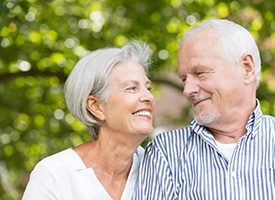 older couple smiling at each other 