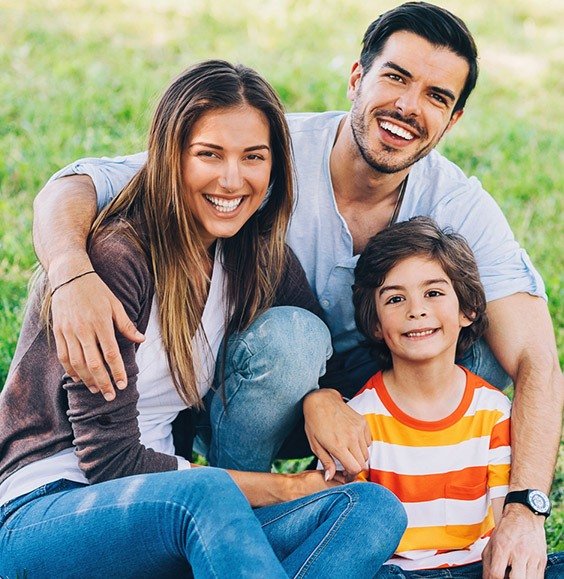 Smiling mother father and child outdoors