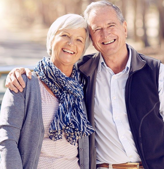 Smiling older man and woman outdoors