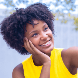 Mother father and two kids smiling outdoors
