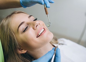 Relaxed woman receiving dental care