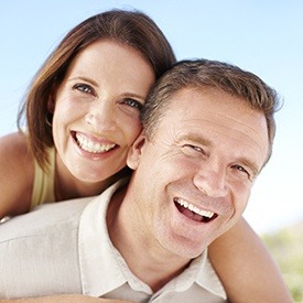 Smiling older man and woman outdoors