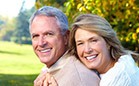 Smiling older man and woman outdoors