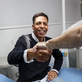 Patient shaking dentist’s hand