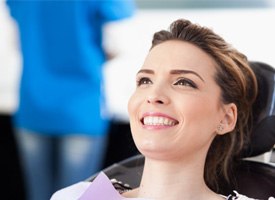 Female dental patient smiling after TMJ treatment in Acworth, GA