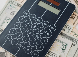 Calculator on stack of cash