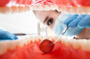 A dentist examining a patient’s gums.