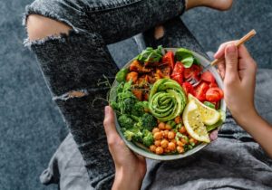 Eating salad, wondering how a vegan diet affects oral health