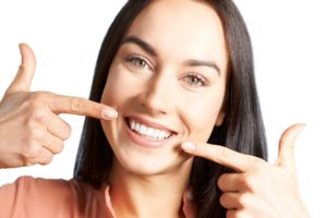 Woman pointing to healthy teeth