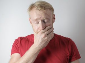 Man with hand on face from jaw pain