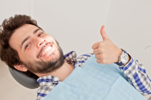 a dental patient smiling during an appointment