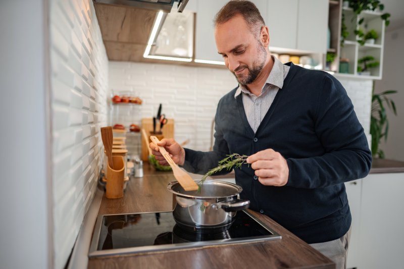 Patient with good oral health adding spices to food